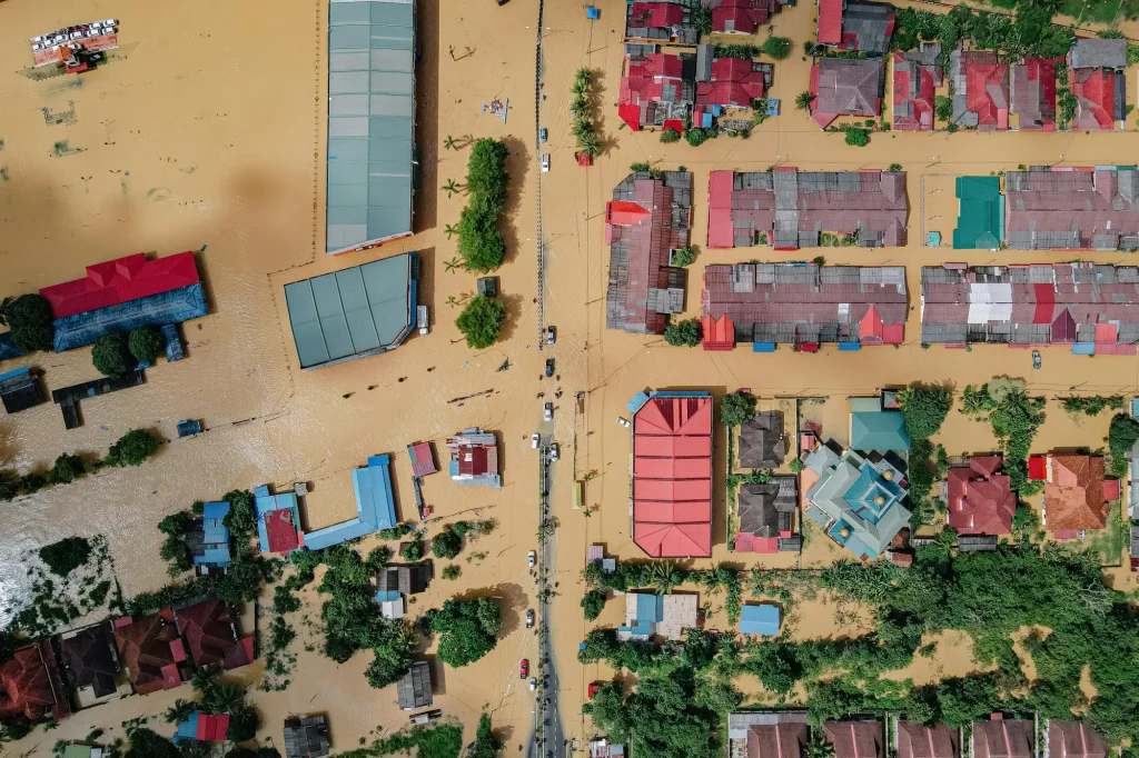 Flooded Malaysian village showing the relationship between natural disasters and property market in Malaysia.