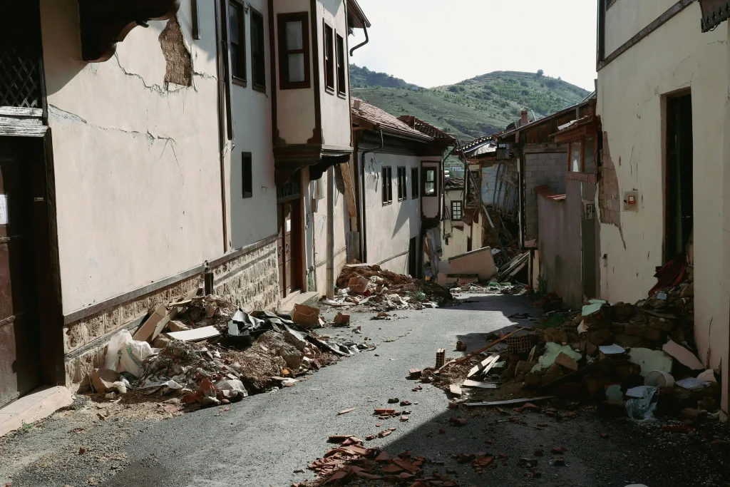 A natural disaster affecting the property market in Malaysia showing damaged houses in the aftermath of an earthquake.